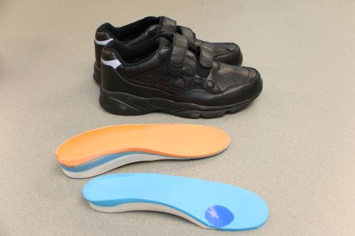 A regular molded orthotic insert and shoes.