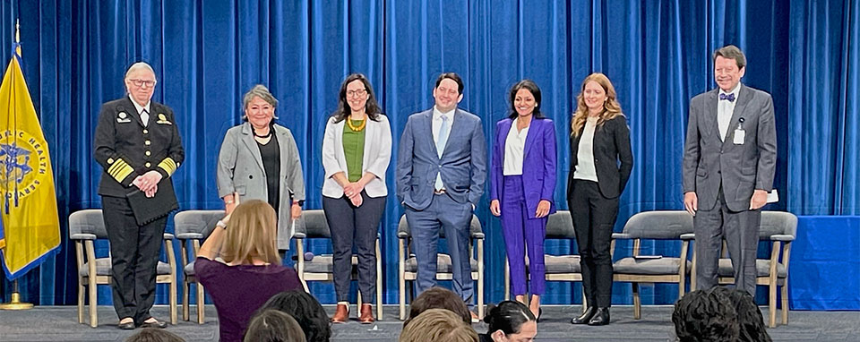 Group portrait of panelists standing onstage at the HHS Intergovernmental and External Affairs leadership webinar event.
