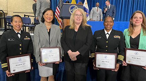Portrait of HRSA awardees (from left to right) Lieutenant Commander Stephanie Lim, Sue Lin, Commander Julia Bryan, and Fraser Byrne with HRSA Administrator Carole Johnson