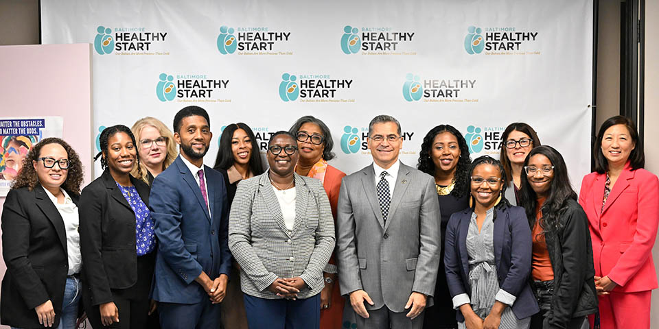 Group portrait with HHS Secretary Xavier Becerra, Baltimore Mayor Brandon M. Scott, Carole Johnson, and Baltimore Healthy Start staff. 