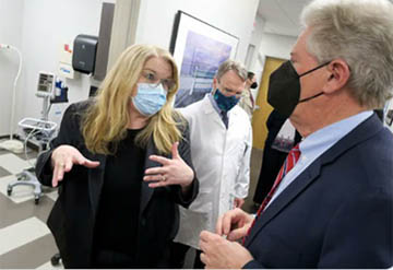 HRSA Administrator Carole Johnson talks with New Jersey Congressman Frank Pallone while touring the offices of the Visiting Nurse Association of Central New Jersey. 