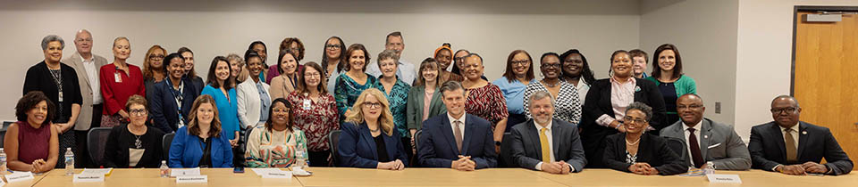 Group portrait of participants at the North Carolina roundtable including Carole Johnson, Micheal Warren, and Kody Kinsley, advocates, mothers, state leaders, and clinicians.