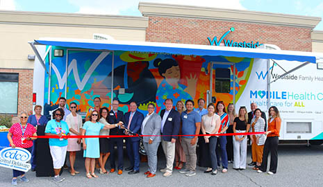 Westside Family Healthcare’s ribbon-cutting ceremony in front of the renovated mobile health unit.