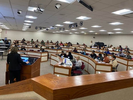 A group partakes in a workshop in a lecture hall