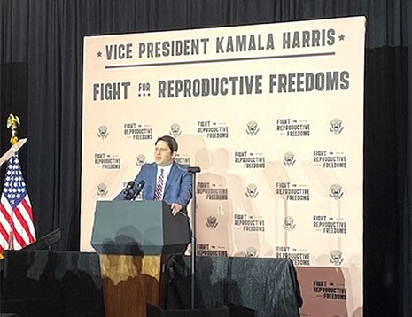 HRSA Deputy Administrator Jordan Grossman speaks from a podium at the Fight For Reproductive Freedoms Tour