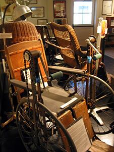 Antique wheelchairs used at the hospital on display.