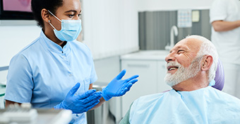A dental health technician is working on patient in a office setting.
