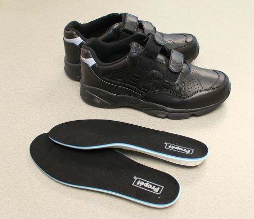 A pair of orthotic shoes and inserts.
