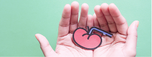 A person is holding a artistic depiction of a kidney.