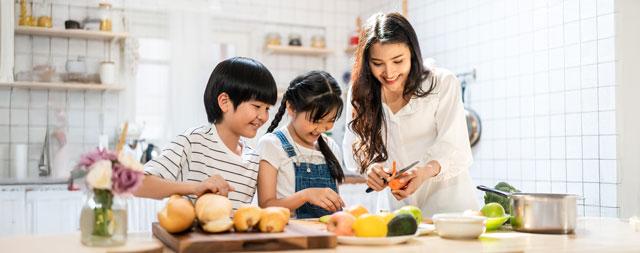 A family preparing a meal with fresh vegetables. 