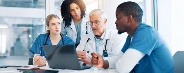 A healthcare team reviewing a patient chart. 